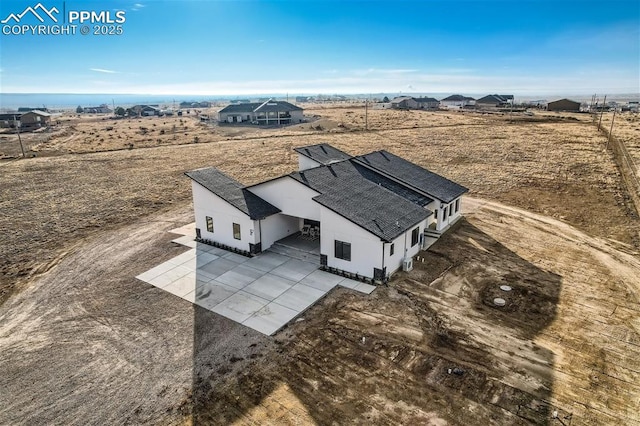 birds eye view of property with a rural view