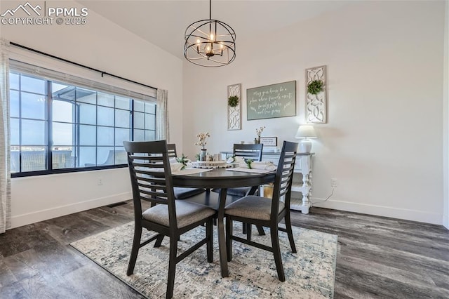 dining space with an inviting chandelier and dark hardwood / wood-style flooring