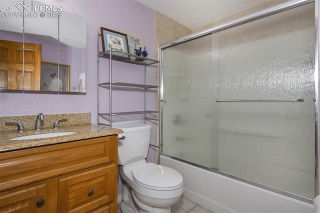 full bathroom with bath / shower combo with glass door, vanity, and toilet