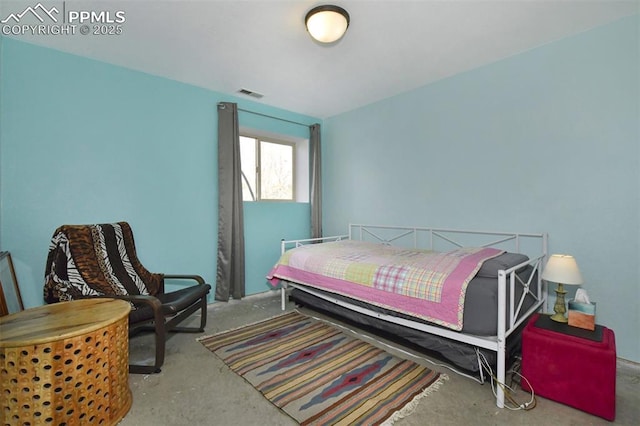 bedroom featuring concrete flooring