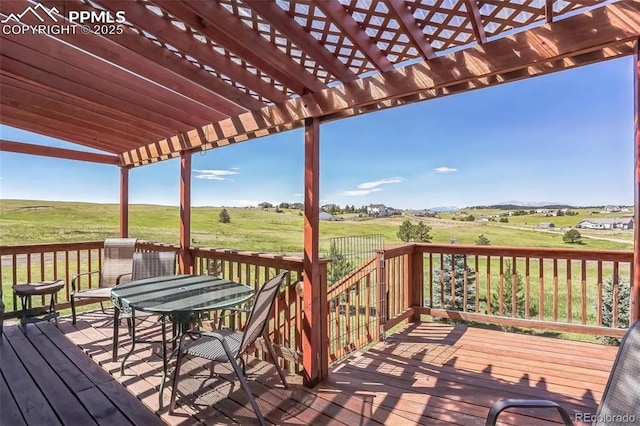 deck featuring a rural view and a pergola