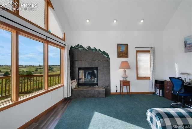 living room with a fireplace, vaulted ceiling, and dark colored carpet