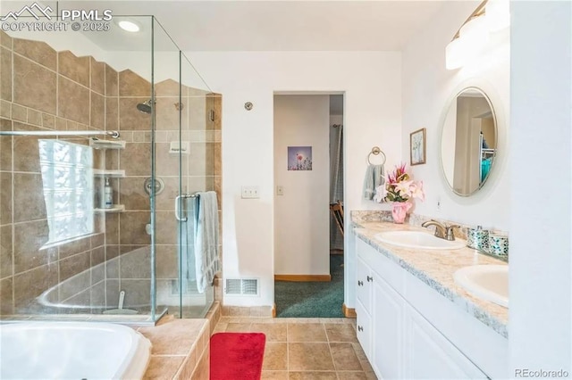 bathroom featuring vanity, shower with separate bathtub, and tile patterned flooring