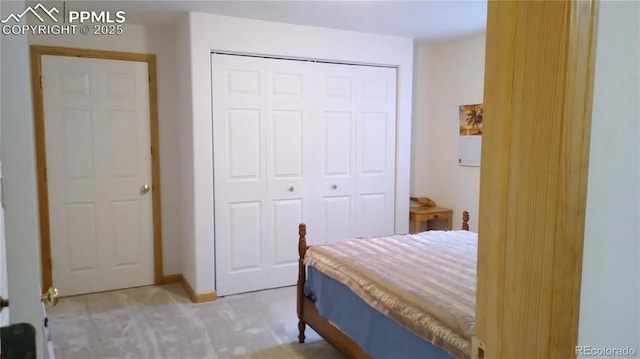 bedroom featuring light colored carpet and a closet