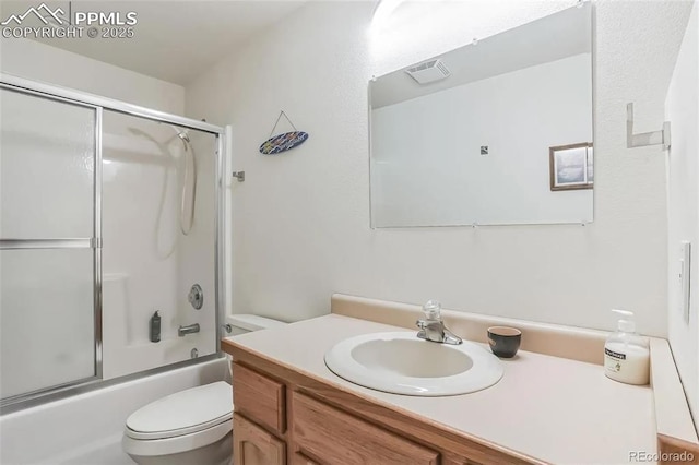 full bathroom with vanity, toilet, and combined bath / shower with glass door