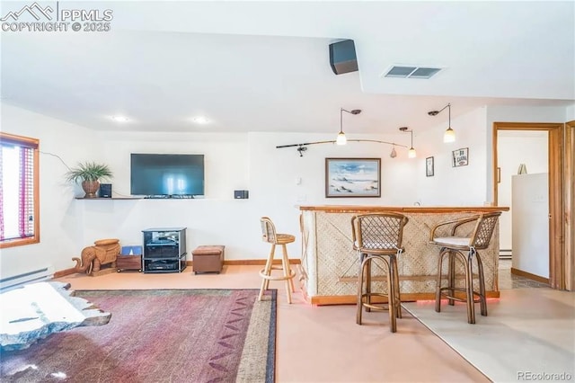 interior space with decorative light fixtures and baseboard heating