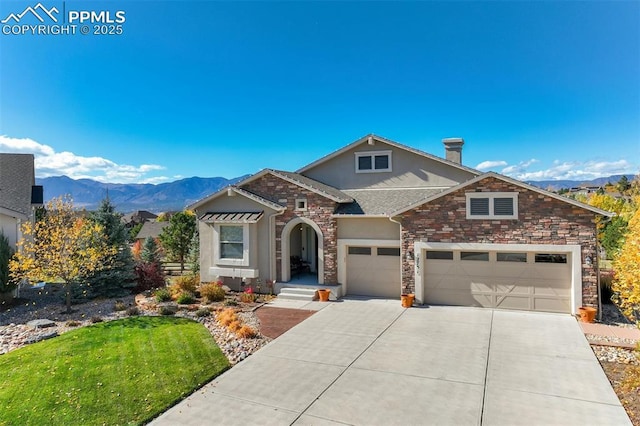 view of front of property with a garage, a mountain view, and a front lawn