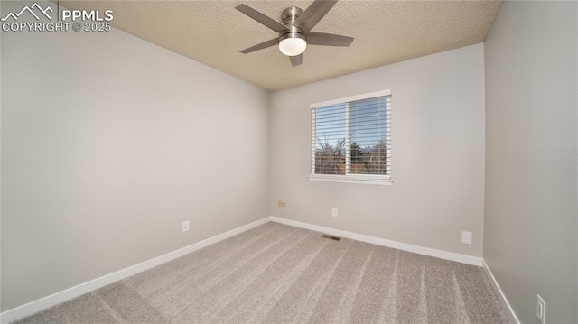 spare room with carpet, ceiling fan, and a textured ceiling