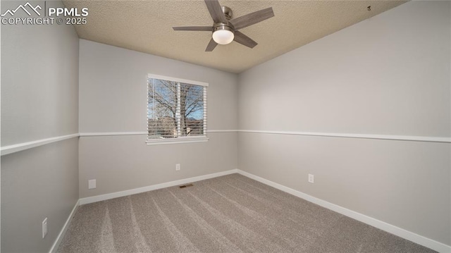 spare room featuring ceiling fan, carpet, and a textured ceiling