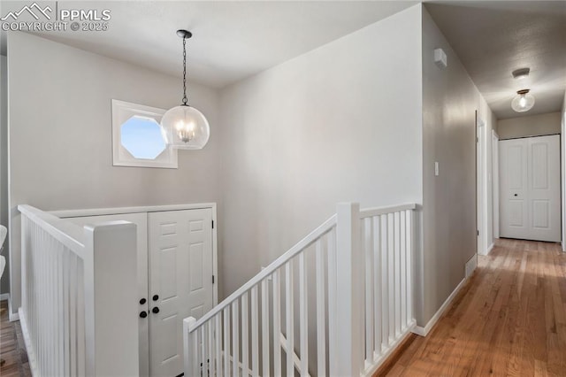 foyer entrance featuring an inviting chandelier and wood-type flooring