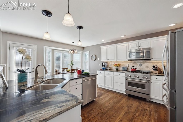 kitchen with white cabinetry, appliances with stainless steel finishes, and hanging light fixtures