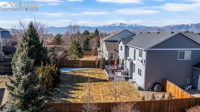 view of side of property featuring a yard and a mountain view