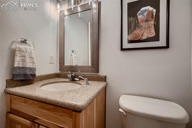 bathroom with toilet and vanity