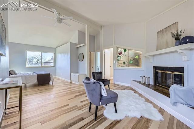 interior space featuring light hardwood / wood-style floors, lofted ceiling, and ceiling fan