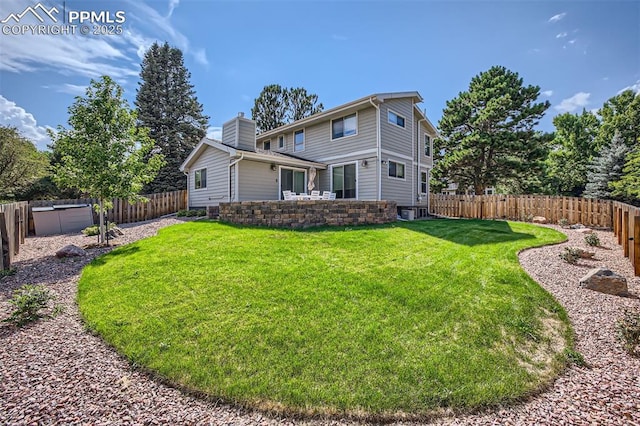 rear view of house with a lawn