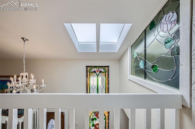 details with a skylight and an inviting chandelier