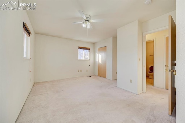 unfurnished room with ceiling fan and light colored carpet