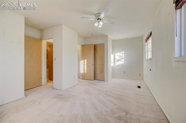 spare room featuring ceiling fan and light colored carpet