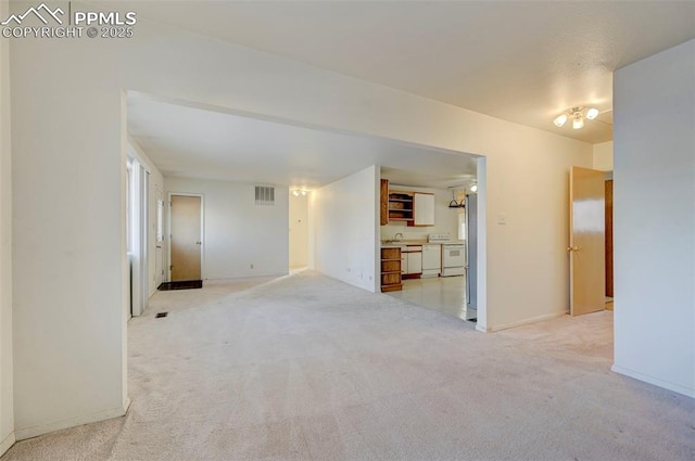 unfurnished room featuring light colored carpet