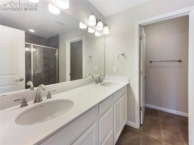 bathroom with walk in shower, vanity, and tile patterned flooring