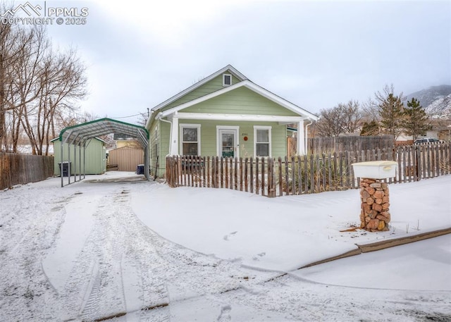 bungalow-style home featuring a carport and covered porch