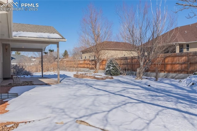 view of yard layered in snow