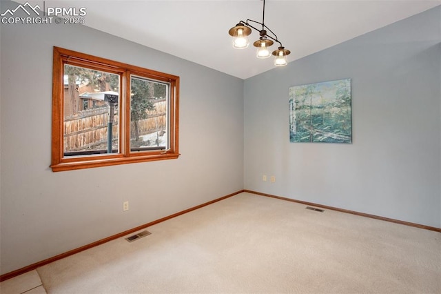 empty room featuring carpet flooring and vaulted ceiling