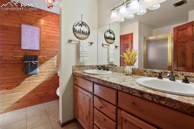 bathroom featuring walk in shower, vanity, toilet, and tile patterned flooring