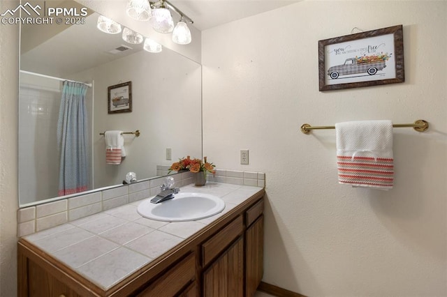 bathroom with vanity and curtained shower