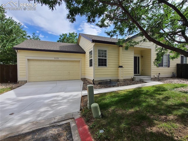 single story home featuring a garage and a front yard