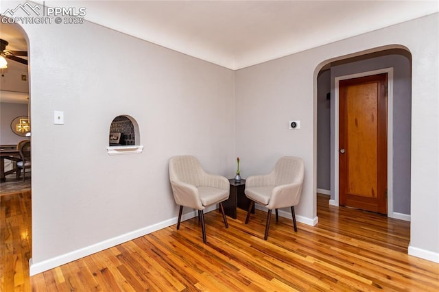 sitting room featuring ceiling fan and light wood-type flooring