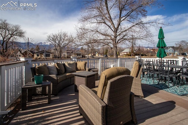 wooden terrace with an outdoor hangout area