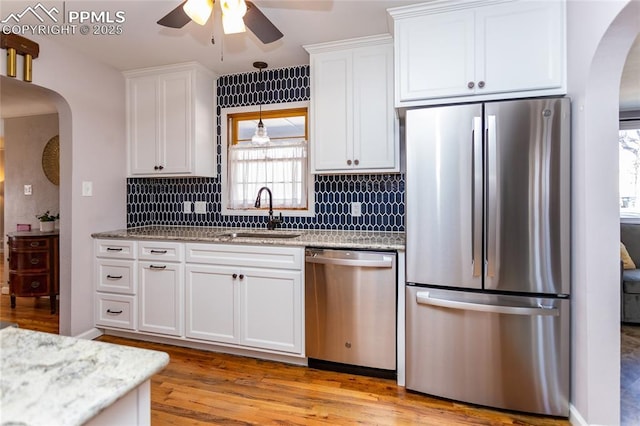 kitchen with sink, stainless steel appliances, white cabinets, and ceiling fan