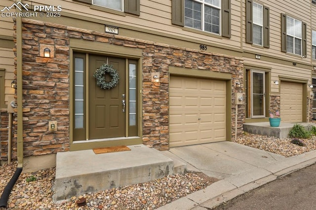 view of exterior entry with a garage