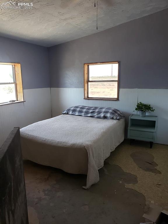 bedroom featuring concrete floors