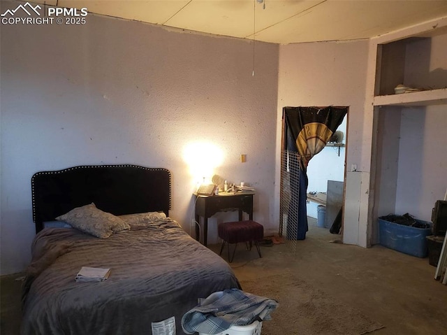 bedroom featuring concrete flooring