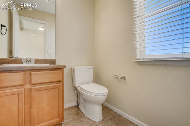 bathroom featuring toilet, tile patterned flooring, and vanity