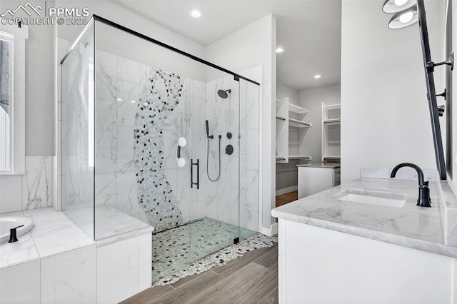 bathroom with separate shower and tub and vanity