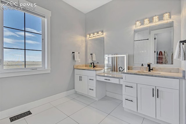 bathroom featuring tile patterned floors, walk in shower, and vanity