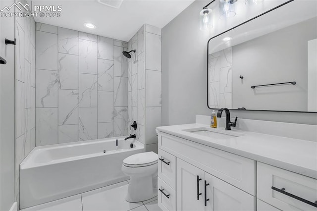 full bathroom featuring toilet, tiled shower / bath combo, tile patterned floors, and vanity