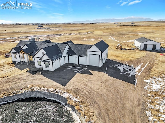 birds eye view of property with a mountain view and a rural view