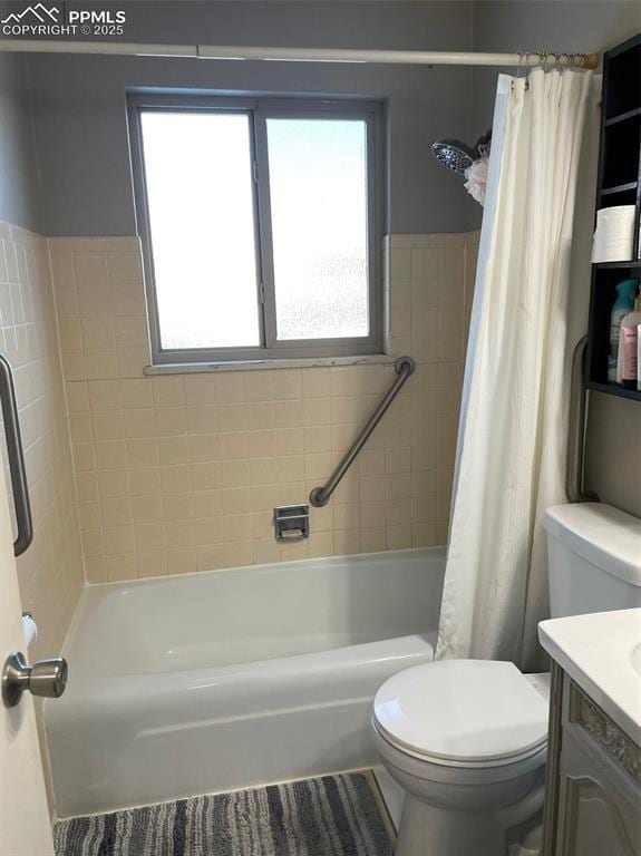 full bathroom featuring toilet, vanity, and shower / bathtub combination with curtain