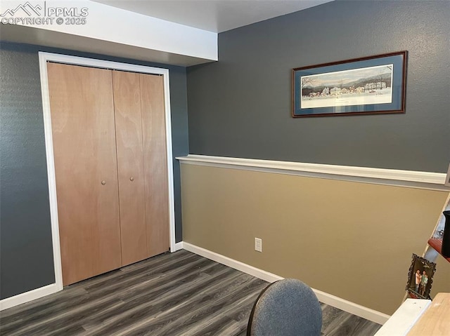 unfurnished bedroom with a closet and dark hardwood / wood-style floors