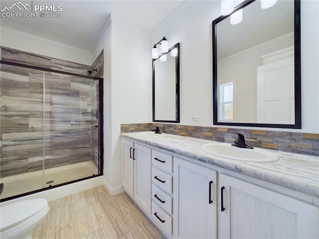 bathroom with toilet, tasteful backsplash, an enclosed shower, ornamental molding, and vanity