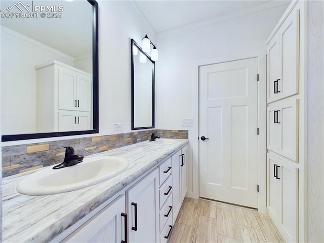 bathroom with tasteful backsplash, vanity, and ornamental molding