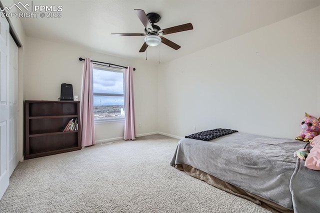 carpeted bedroom with a ceiling fan, baseboards, and a closet