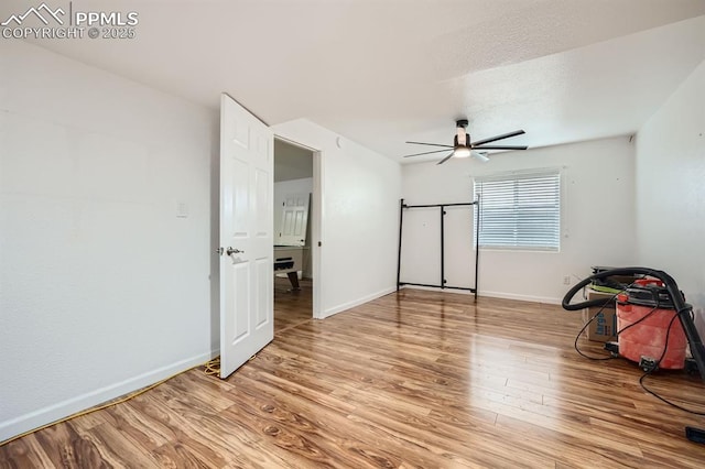 unfurnished bedroom with ceiling fan, light wood finished floors, and baseboards