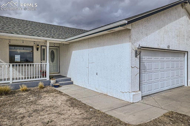 property entrance featuring a porch, an attached garage, driveway, roof with shingles, and stucco siding