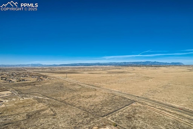 birds eye view of property featuring a mountain view