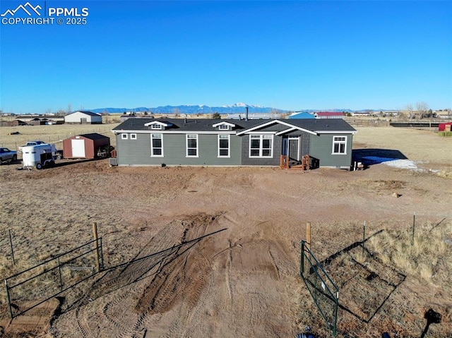 view of front of property featuring a storage shed